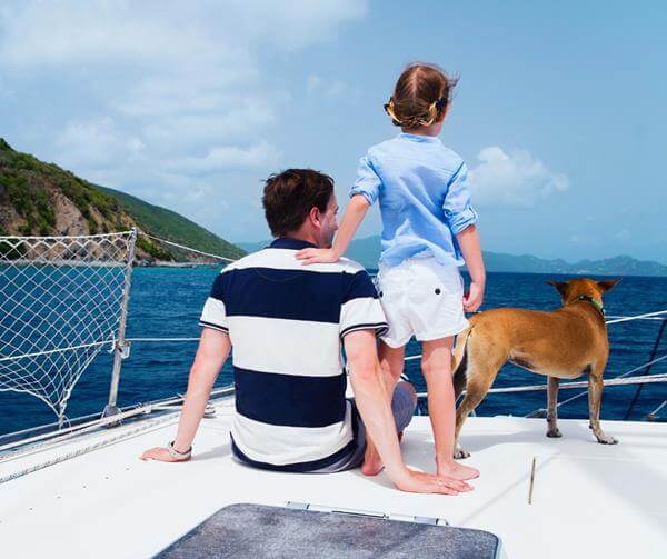 child, parent and a dog on the boat