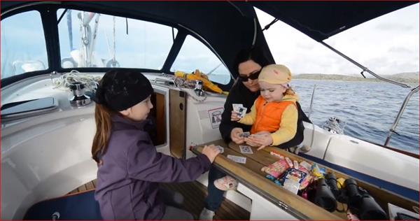 family playing cards on the boat